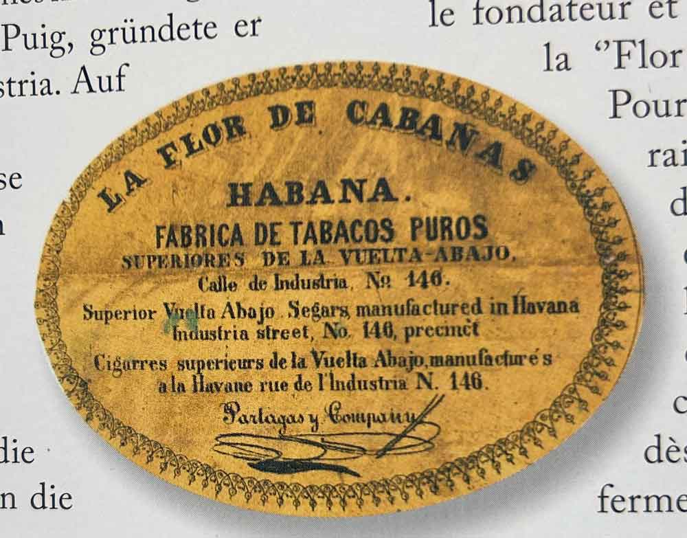 La marca Cabañas ya era tan famosa y apreciada alrededor de 1840 que incluso Jaime Partagás „robó“ este nombre para vender sus propios puros. Arriba dice: La Flor de Cabañas. Abajo y mucho más pequeño: Partagás y Company. (Fuente: Amir Saarony y colaboradores: “Partagás – El Libro”, ISBN: 978 0 9879290 1 3)